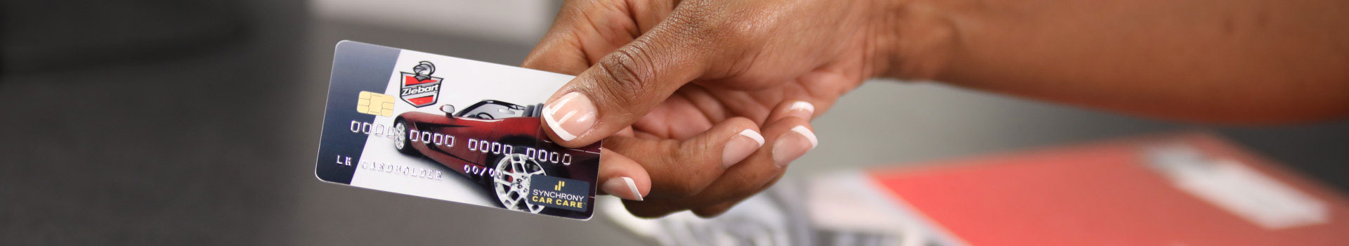 Hands holding a Ziebart credit card